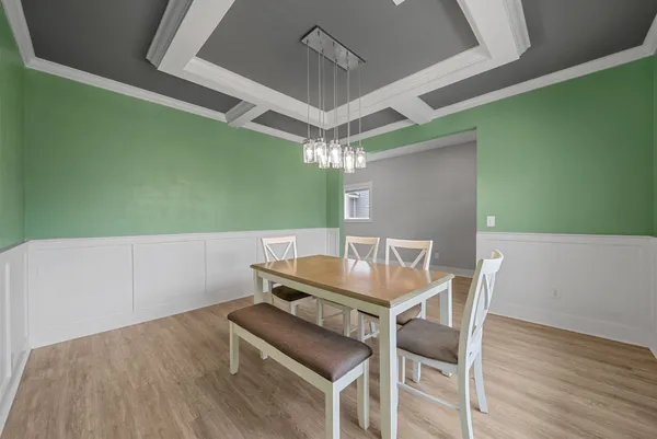 a view of a dining room with furniture and chandelier