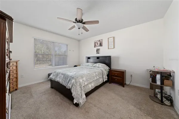 a bedroom with a bed dresser and a window