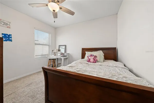 a bedroom with a bed and window
