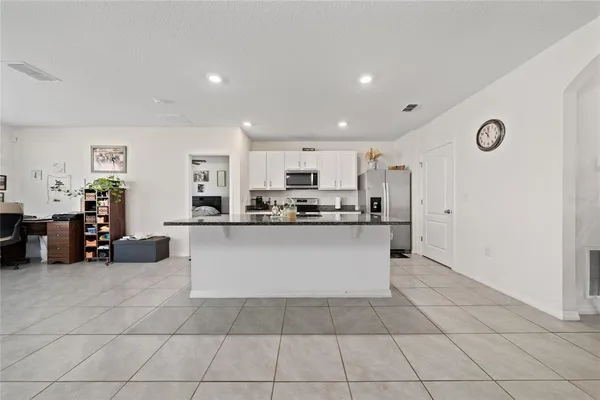 a large white kitchen with cabinets