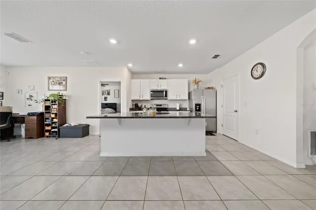 a large white kitchen with cabinets