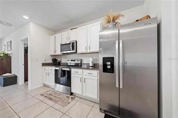 a kitchen with a refrigerator sink and microwave