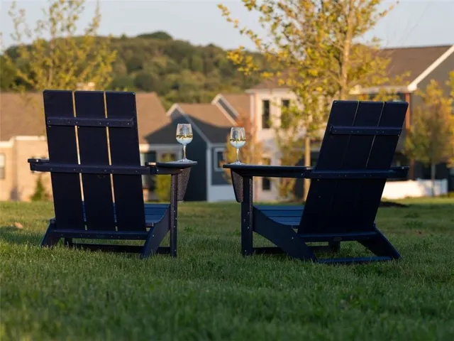 a view of a backyard with couches chair and fire pit