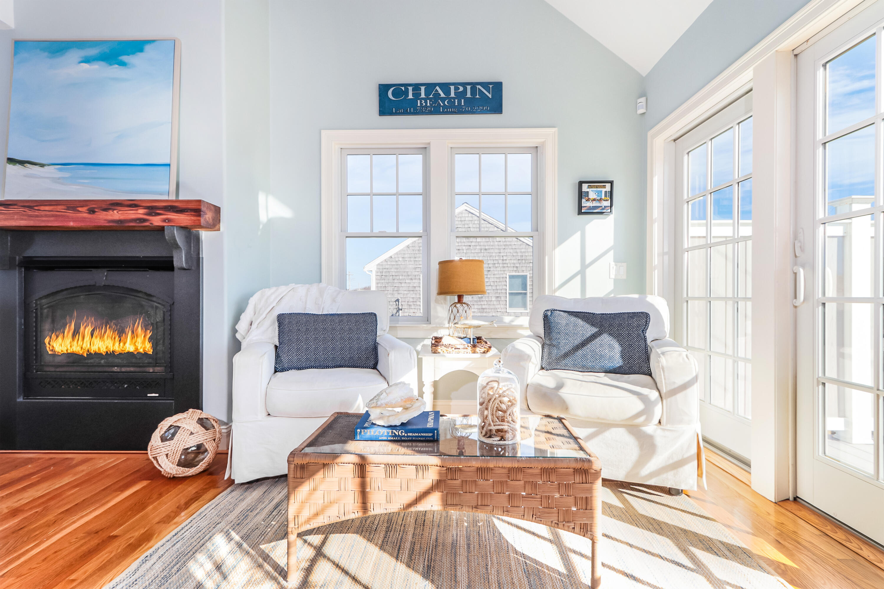 19 Dr Botero Road Dennis, MA 02638 - Photo 7 of 42 a living room with furniture a fireplace and a floor to ceiling window