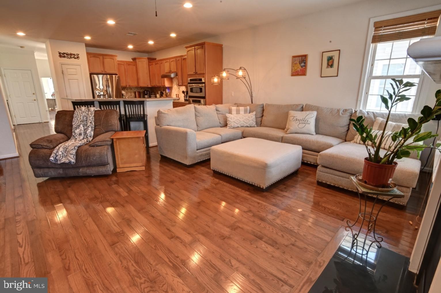 13170 Triple Crown Loop Gainesville, VA 20155 - Photo 26 of 71 a living room with furniture and a wooden floor