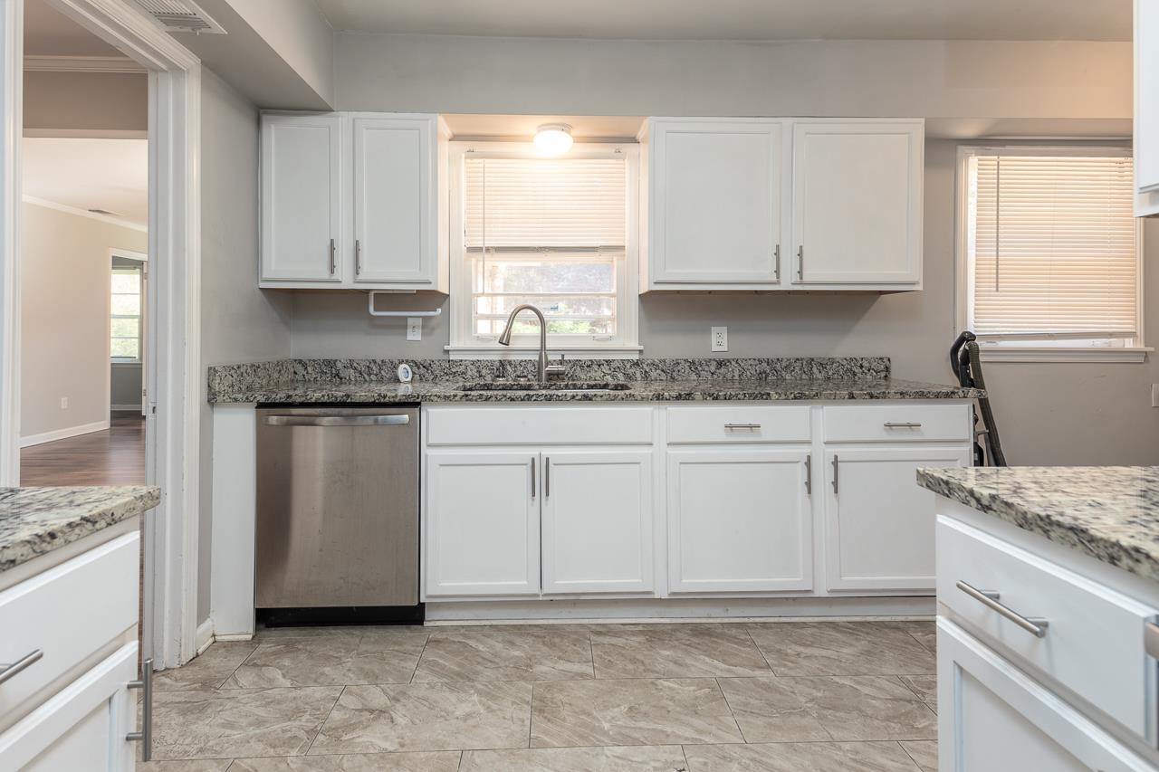 4606 Helene Road Memphis, TN 38117 - Photo 3 of 10 a kitchen with granite countertop white cabinets and white appliances