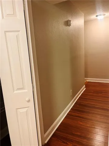 a view of hallway with wooden floor