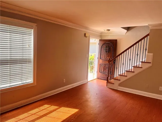 a view of entryway and hall with wooden floor