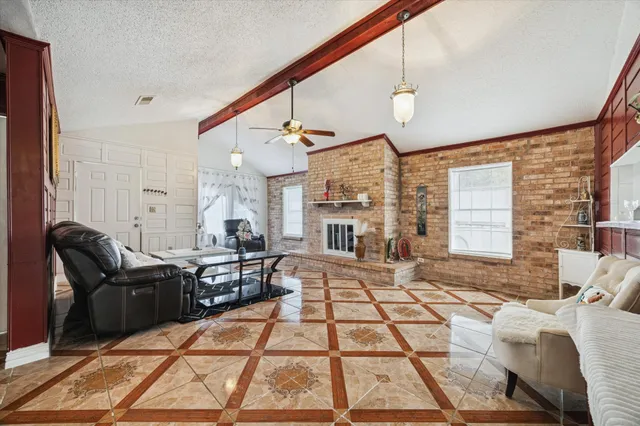 a living room with furniture a fireplace and a flat screen tv