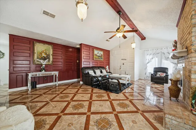 a living room with furniture a rug and white walls