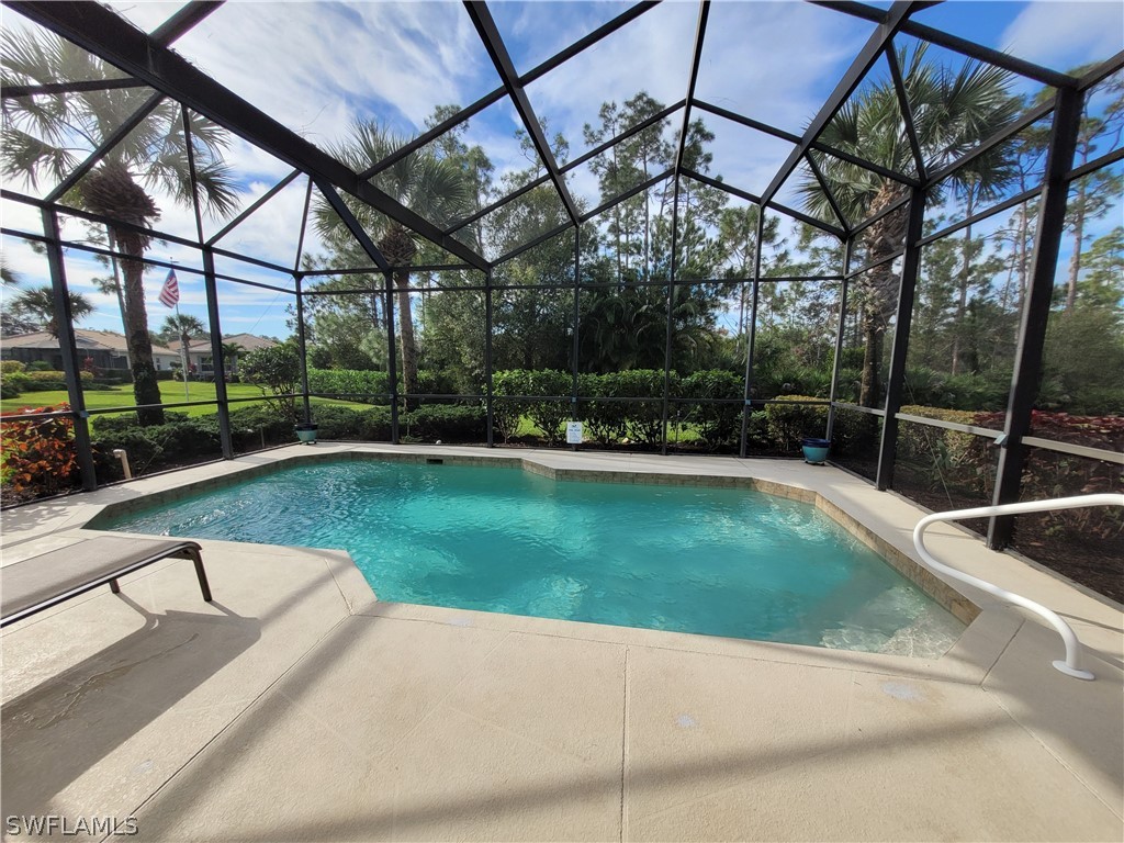 a view of a backyard patio and swimming pool