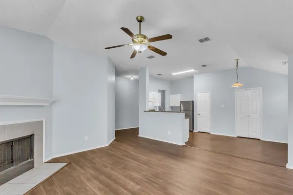 a view of a kitchen with microwave and a fireplace