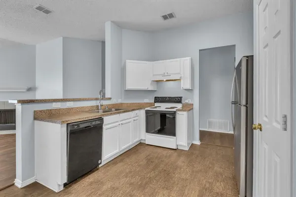 a kitchen with a stove sink and refrigerator