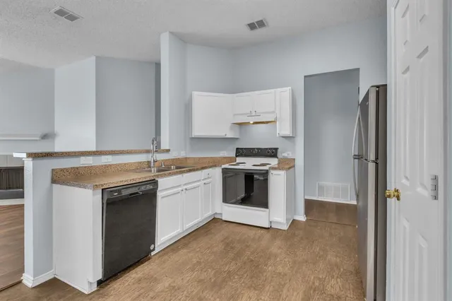 a kitchen with a stove sink and refrigerator