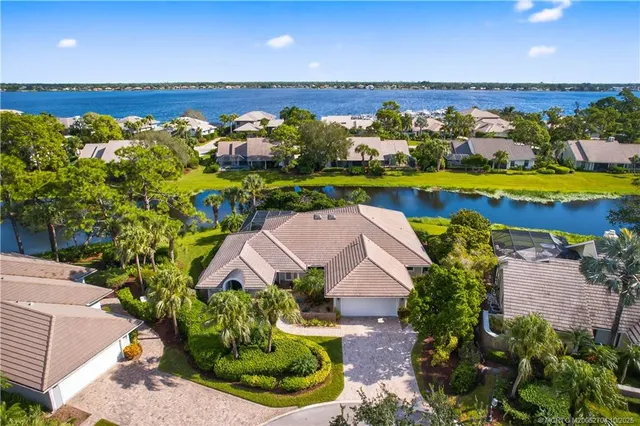 an aerial view of a house with a swimming pool outdoor seating and yard