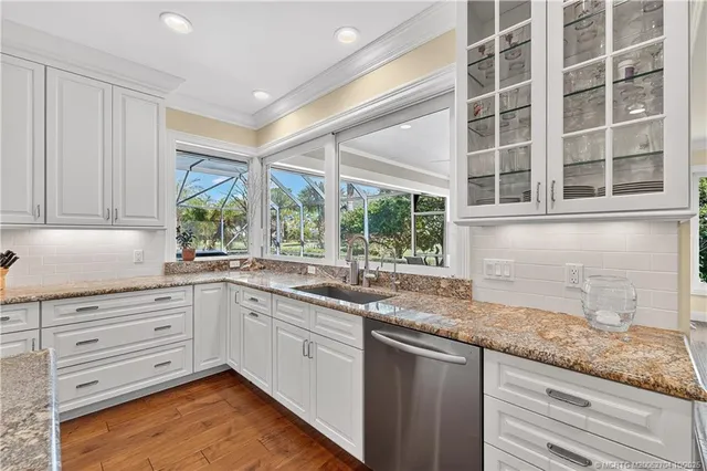 a kitchen with a sink stove and cabinets