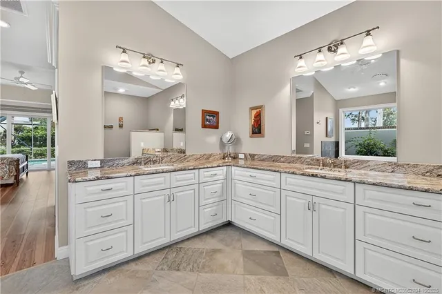 a bedroom with a bed and large windows