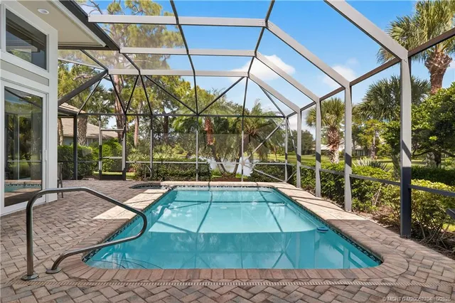 an aerial view of house with a garden and lake view