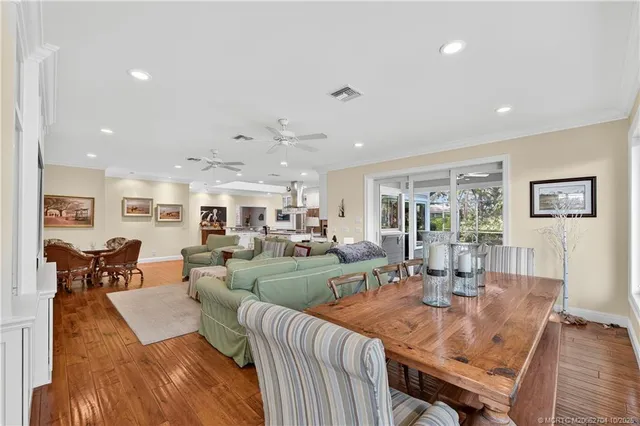 a living room with furniture a large window and a flat screen tv