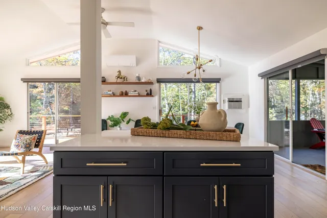 a room with a large window and wooden floor