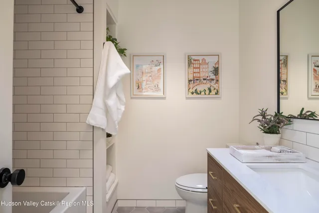 a bathroom with a sink a toilet and shower curtain