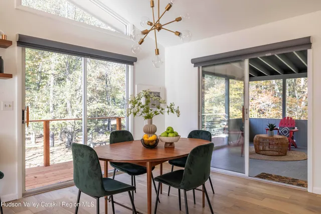 a dining room with furniture window and wooden floor