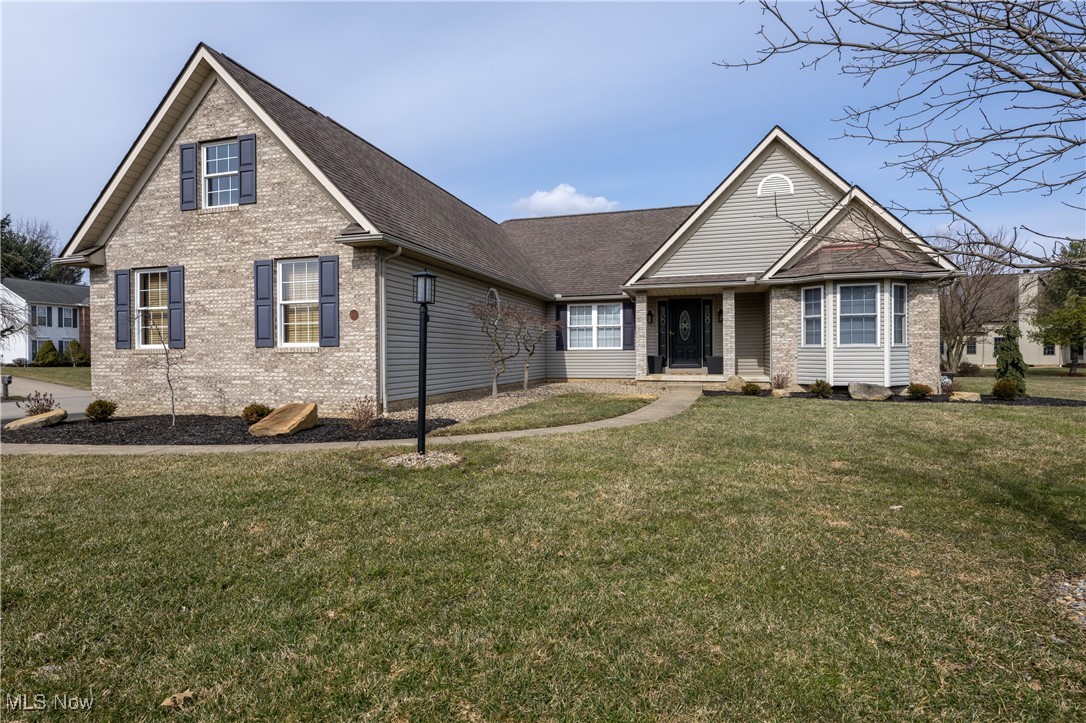 847 Lockwood Road Barberton, OH 44203 - Photo 2 of 29 Traditional home featuring brick siding, roof with shingles, and a front yard