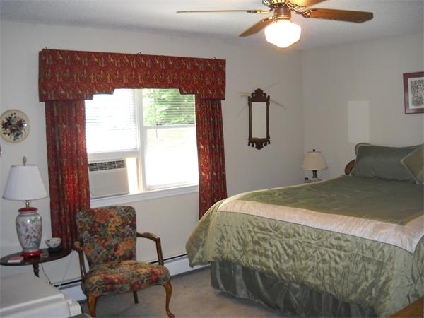 160 Pierce Road Townsend, MA 01469 - Photo 14 of 23 a bedroom with a bed and chair