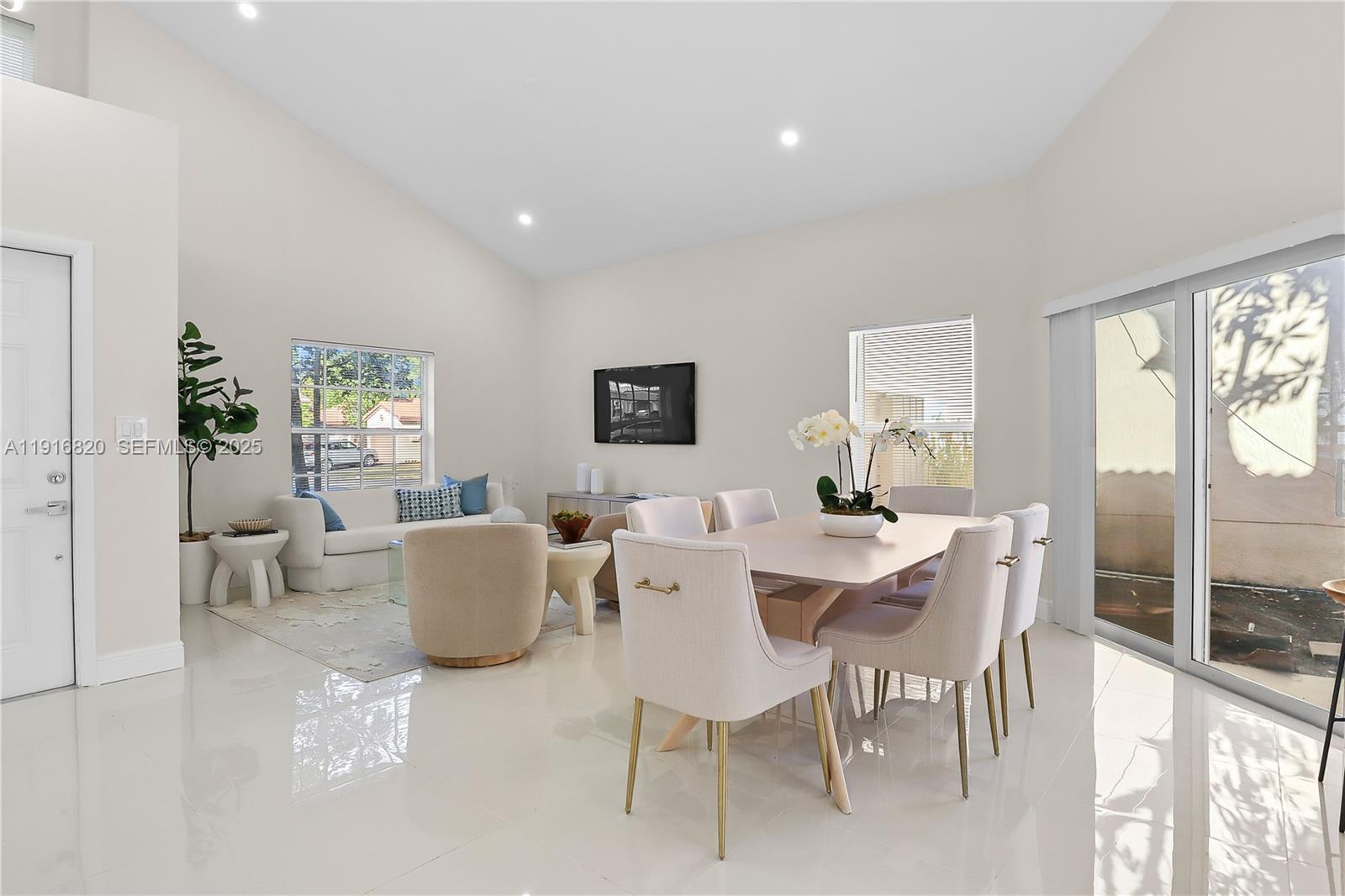 1223 Northwest 125th Terrace Sunrise, FL 33323 - Photo 11 of 89 a dining room with furniture a large window and a rug