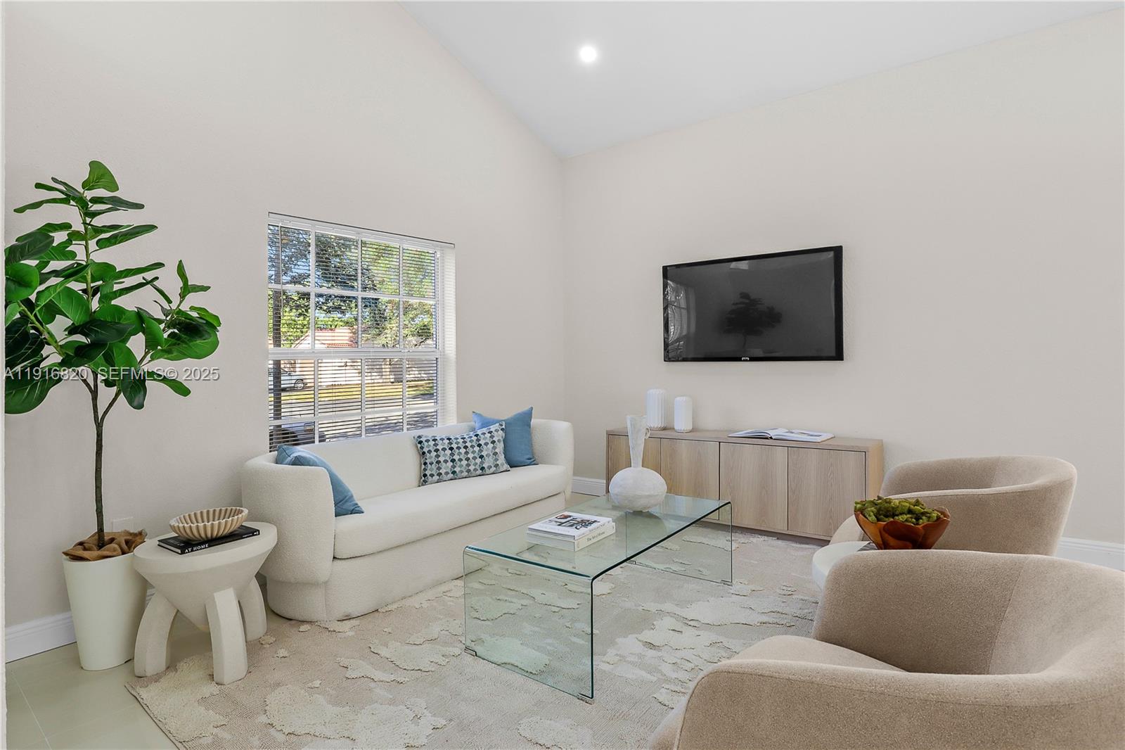 1223 Northwest 125th Terrace Sunrise, FL 33323 - Photo 24 of 89 a living room with furniture a potted plant and a flat screen tv