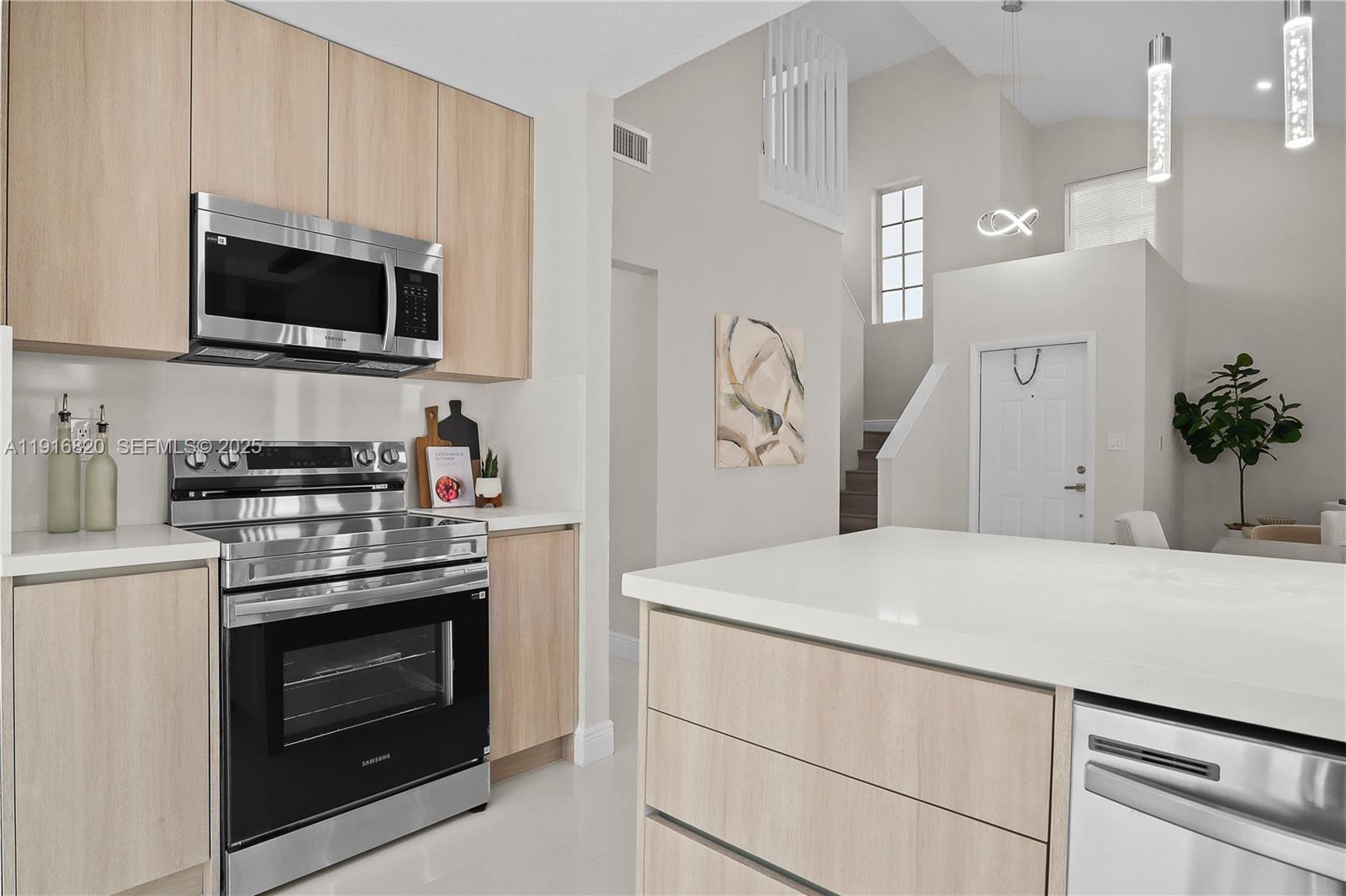 1223 Northwest 125th Terrace Sunrise, FL 33323 - Photo 36 of 89 a kitchen with stainless steel appliances a stove microwave and refrigerator