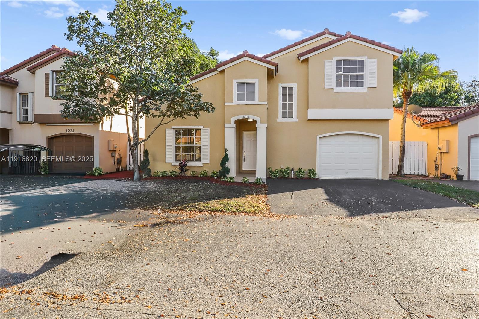 1223 Northwest 125th Terrace Sunrise, FL 33323 - Photo 4 of 89 a front view of a house with a yard and garage