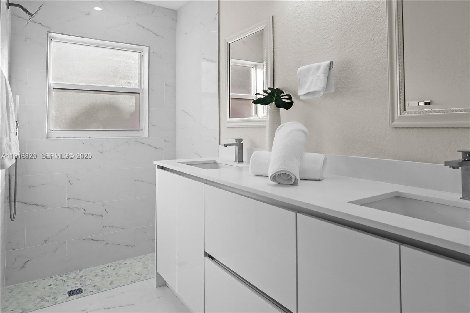 1223 Northwest 125th Terrace Sunrise, FL 33323 - Photo 45 of 89 a bathroom with a sink and a mirror