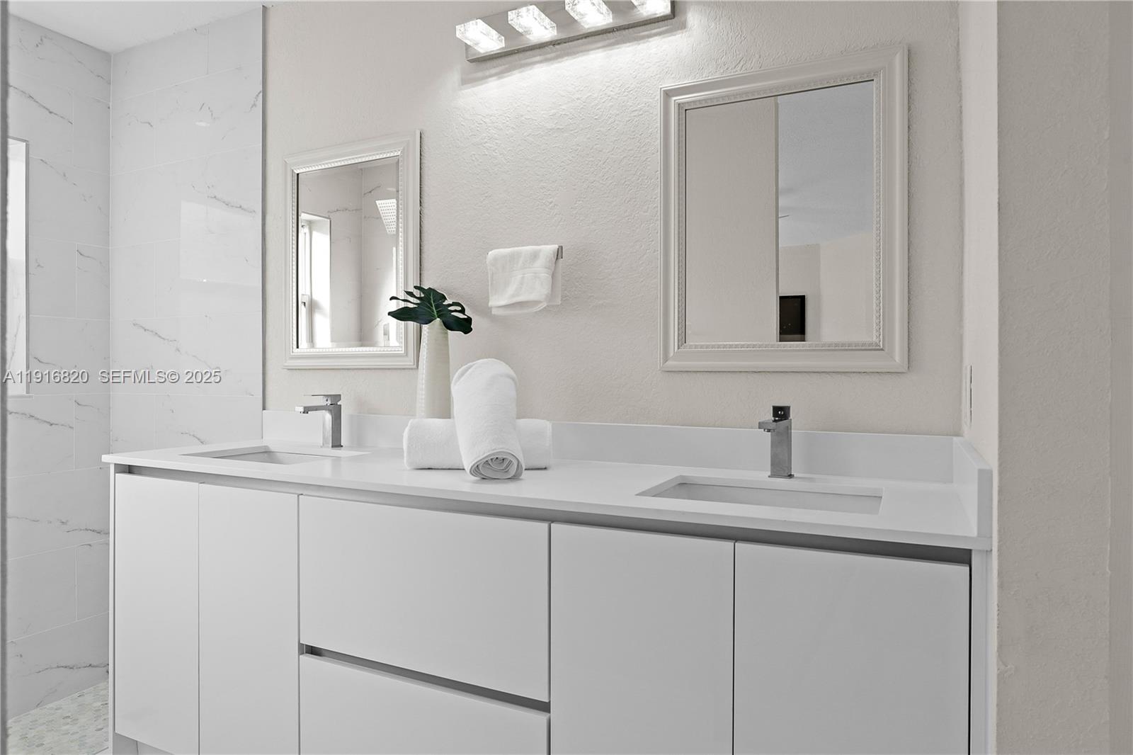 1223 Northwest 125th Terrace Sunrise, FL 33323 - Photo 48 of 89 a bathroom with a sink and a mirror