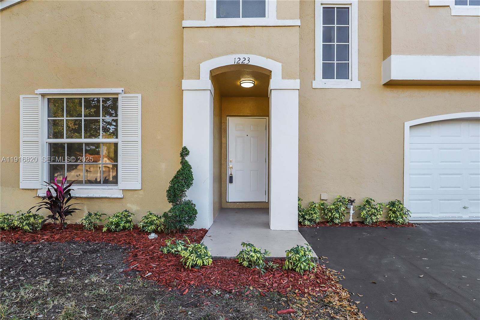 1223 Northwest 125th Terrace Sunrise, FL 33323 - Photo 6 of 89 a front view of a house with a yard