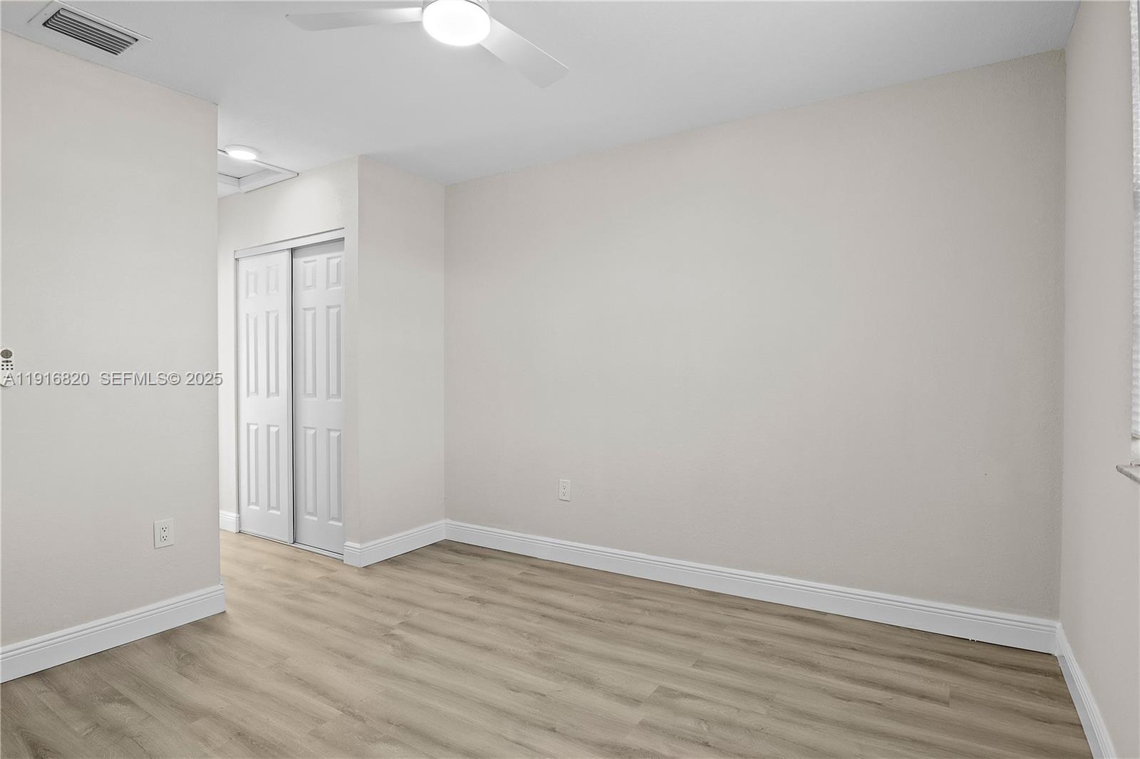 1223 Northwest 125th Terrace Sunrise, FL 33323 - Photo 63 of 89 a view of an empty room with wooden floor