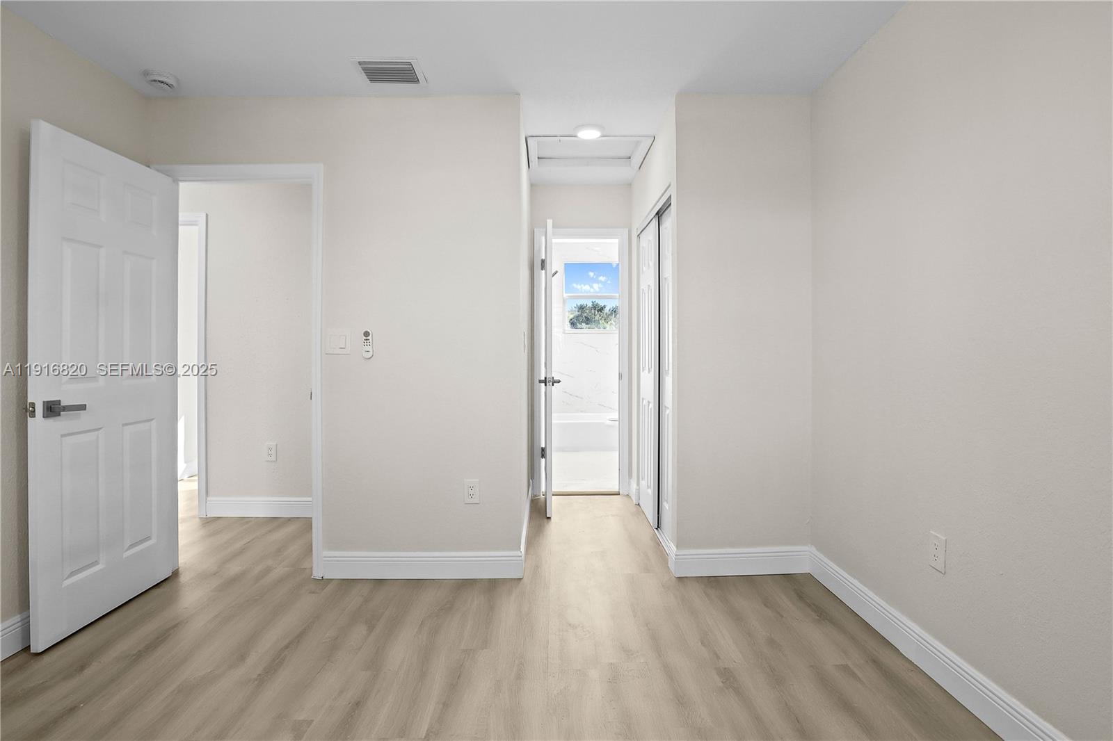 1223 Northwest 125th Terrace Sunrise, FL 33323 - Photo 64 of 89 a view of an empty room and wooden floor