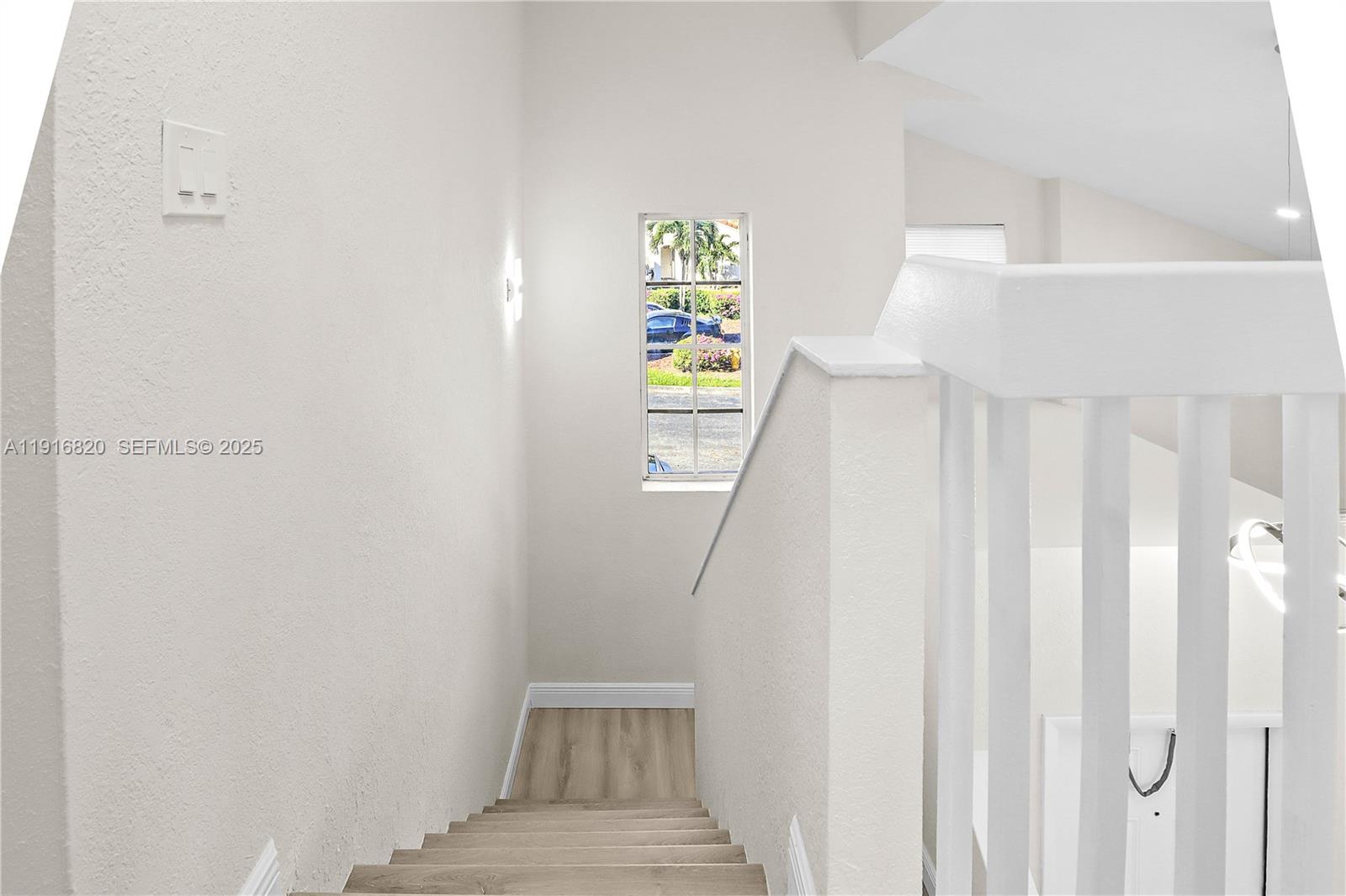 1223 Northwest 125th Terrace Sunrise, FL 33323 - Photo 73 of 89 a view of a hallway with wooden floor and entryway