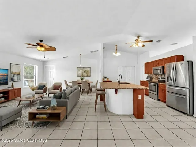 a kitchen with stainless steel appliances granite countertop a sink a counter top space cabinets and stainless steel appliances