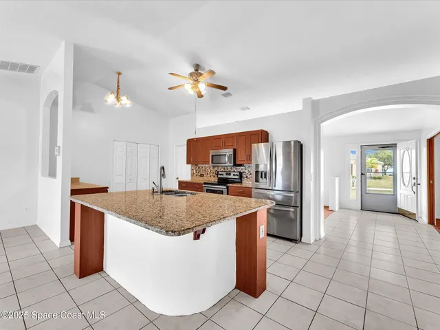 a kitchen with stainless steel appliances granite countertop a sink counter space and cabinets