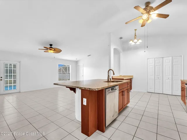 a kitchen with stainless steel appliances granite countertop a refrigerator a stove a sink and a microwave