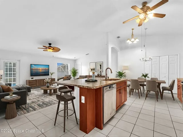 a kitchen with stainless steel appliances granite countertop a sink and a refrigerator