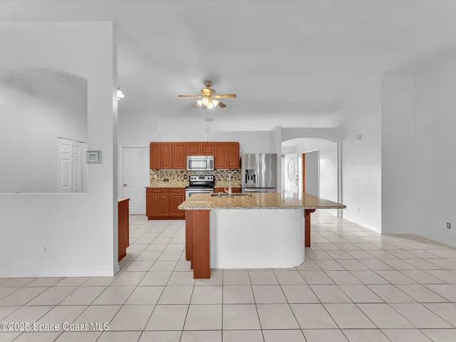 a bathroom with a sink toilet vanity and shower