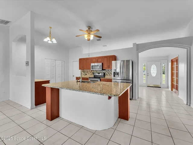 a bedroom with a bed and a chair