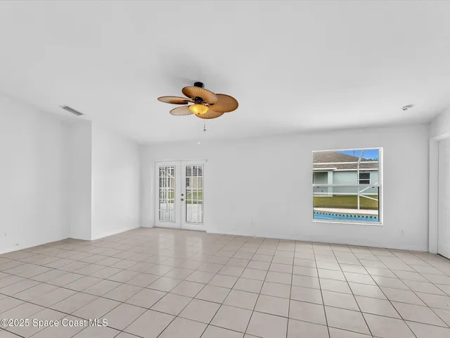 a view of a big room with wooden floor and windows