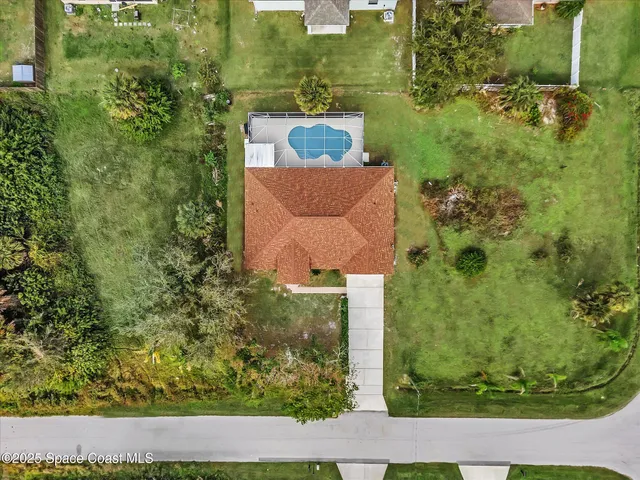 an aerial view of a house with a yard
