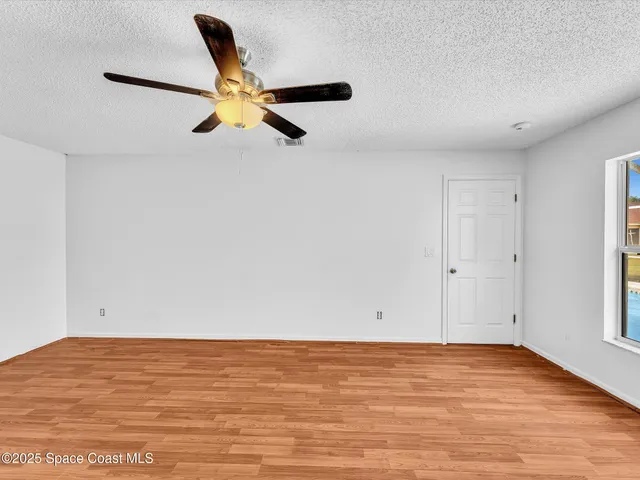 an aerial view of a house with a garden and swimming pool