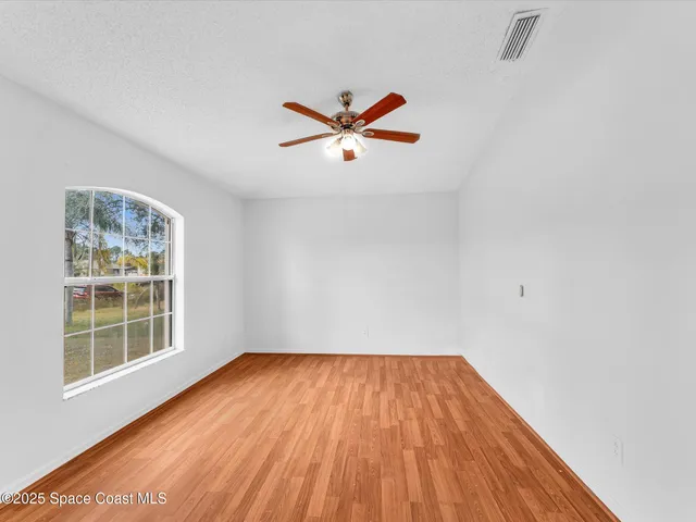 a view of a dining room with furniture and a potted plant