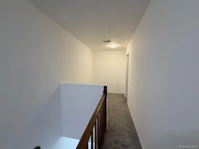 a view of hallway with wooden floor