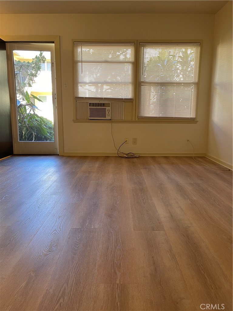 970 Elden Avenue, Unit 3 Los Angeles, CA 90006 - Photo 2 of 10 an empty room with wooden floor and windows